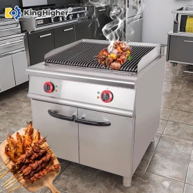 commercial electric lava rock grill cooking skewers in professional kitchen
